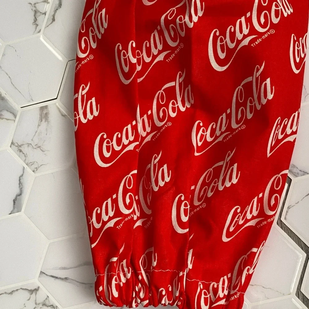 Handmade wall hanging grocery bags organizer and pantry with Coca Cola logo.